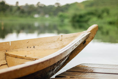 Close-up of boat moored at lake