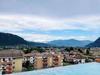 Town by mountains against sky