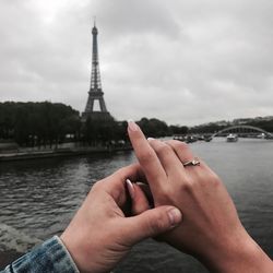 Midsection of man holding woman with tower in background