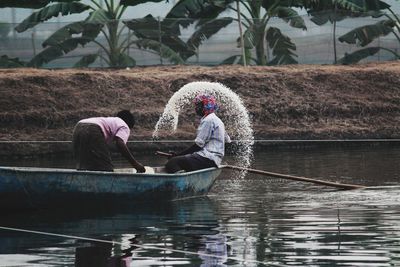 Man working on boat in water