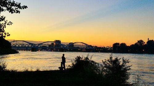 People in river at sunset