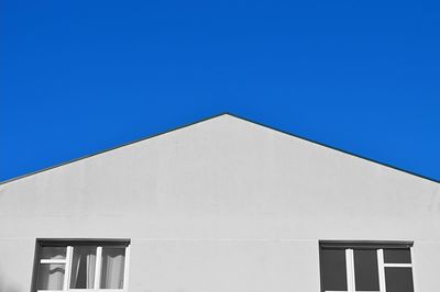 High section of building against clear blue sky