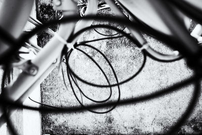 Close-up of mobile phone on chainlink fence