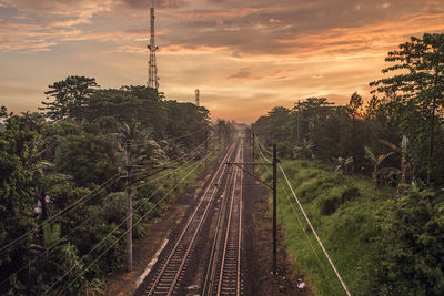 Railway tracks against sky during sunset