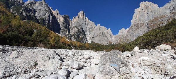 Scenic view of rocky mountains against clear blue sky