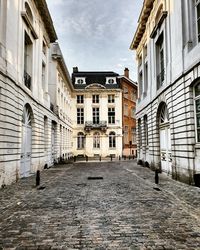 Empty alley amidst buildings in city