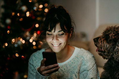 Young woman using mobile phone at home