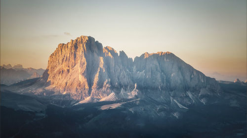 Scenic view of snowcapped mountains against sky during sunset