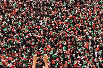 Close-up of crowd holding mexican flags