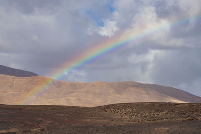 Desert landscape with rainbow on lanzarote island