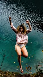 Young woman falling in lake