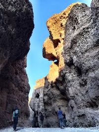 Low angle view of man standing on cliff