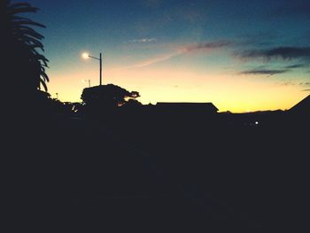 View of illuminated street light against sky at sunset
