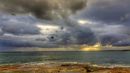 Scenic view of sea against cloudy sky