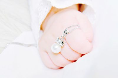 Close-up of baby wearing ring 