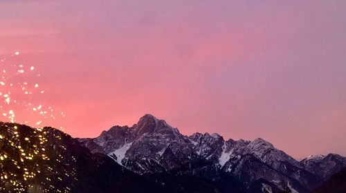 Scenic view of snowcapped mountains against sky during sunset