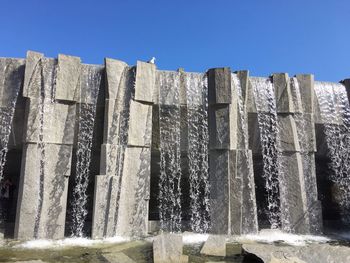 Low angle view of stone stack against clear sky