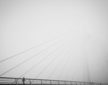 Low angle view of suspension bridge against clear sky