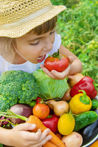 Portrait of boy holding vegetables