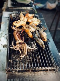 High angle view of meat on barbecue grill