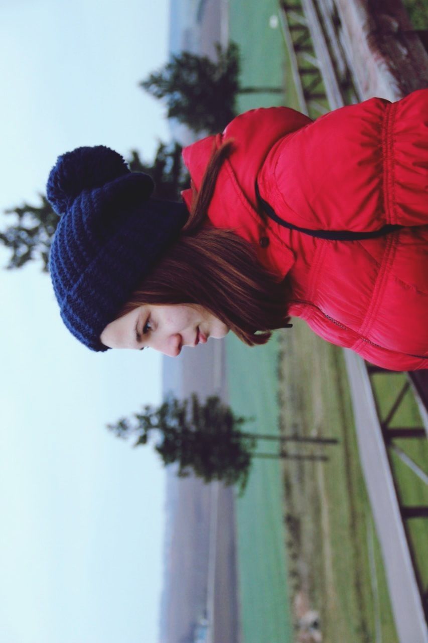 lifestyles, leisure activity, focus on foreground, red, warm clothing, day, casual clothing, outdoors, person, men, rear view, tree, close-up, selective focus, incidental people, hat, umbrella, childhood