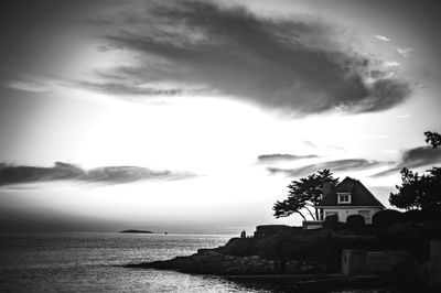 Scenic view of sea by buildings against sky