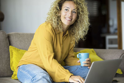 Young woman using laptop at home