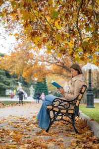 Couple sitting on bench in park