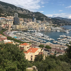 High angle view of townscape by sea against sky