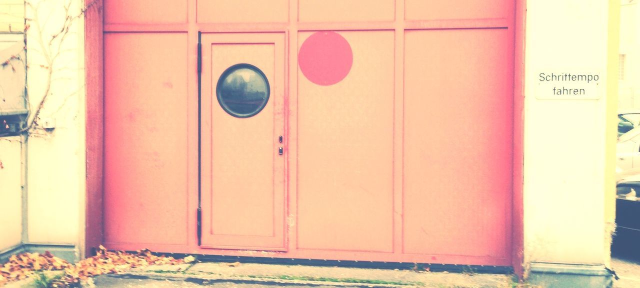 door, built structure, closed, architecture, building exterior, wall - building feature, safety, protection, security, communication, entrance, wall, text, no people, weathered, day, metal, closed door, house, red