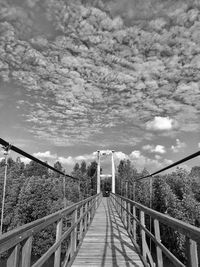 Rear view of woman walking on footbridge