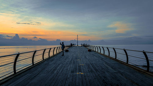 Pier over sea against sky during sunset wharf