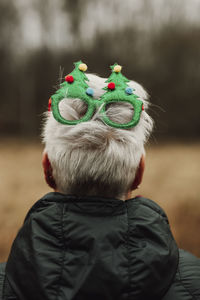Rear view of woman wearing christmas glasses