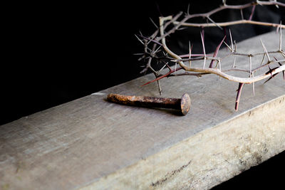 Close-up of rusty metal on table against black background