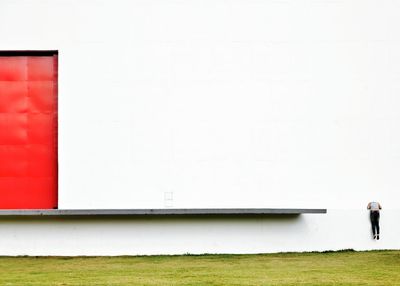 Rear view of person climbing wall