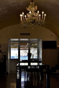 Illuminated chandelier on table at home