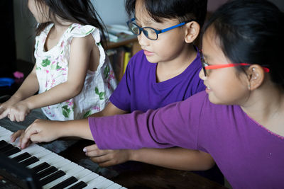 Cute kids playing piano