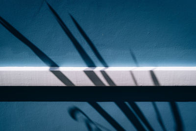 High angle view of shadow on railing