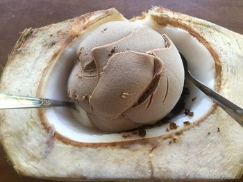 High angle view of ice cream in coconut on table