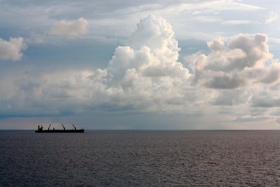 Scenic view of sea against cloudy sky