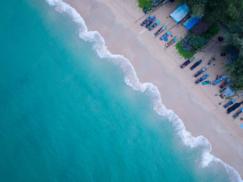 Top view or aerial view of beautiful waves crashing on sandy shore and beach
