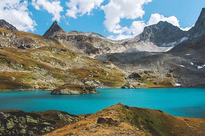 Scenic view of lake and mountains against sky