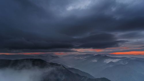 Scenic view of mountains against dramatic sky