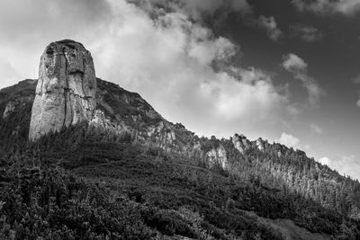 Low angle view of rock formations against sky