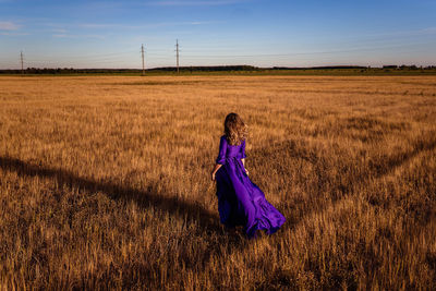 Rear view of woman on field