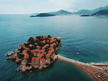 High angle view of buildings in town amidst sea