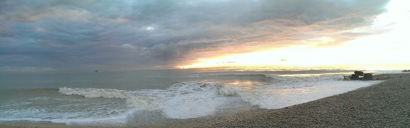 Scenic view of sea against cloudy sky