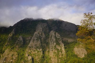 Scenic view of mountain against cloudy sky