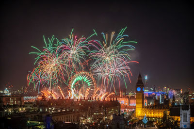 High angle view of firework display at night