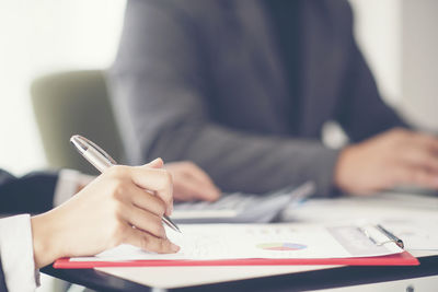 Business people working at table in office